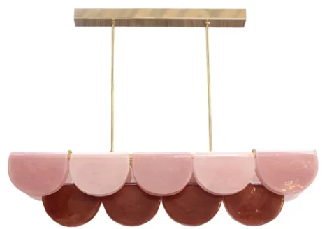 Elongated pink red multicoloured Murano glass chandelier with brass frame in modern interior.