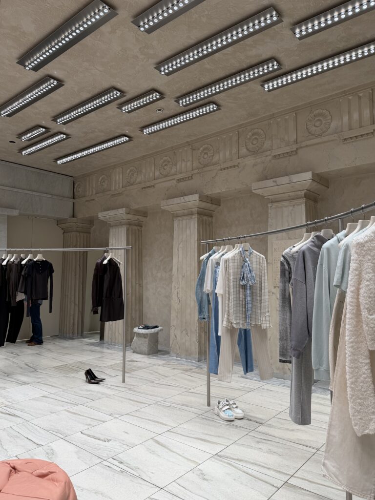 Acne Studios Stockholm flagship store interior with historic marble columns and contemporary retail displays